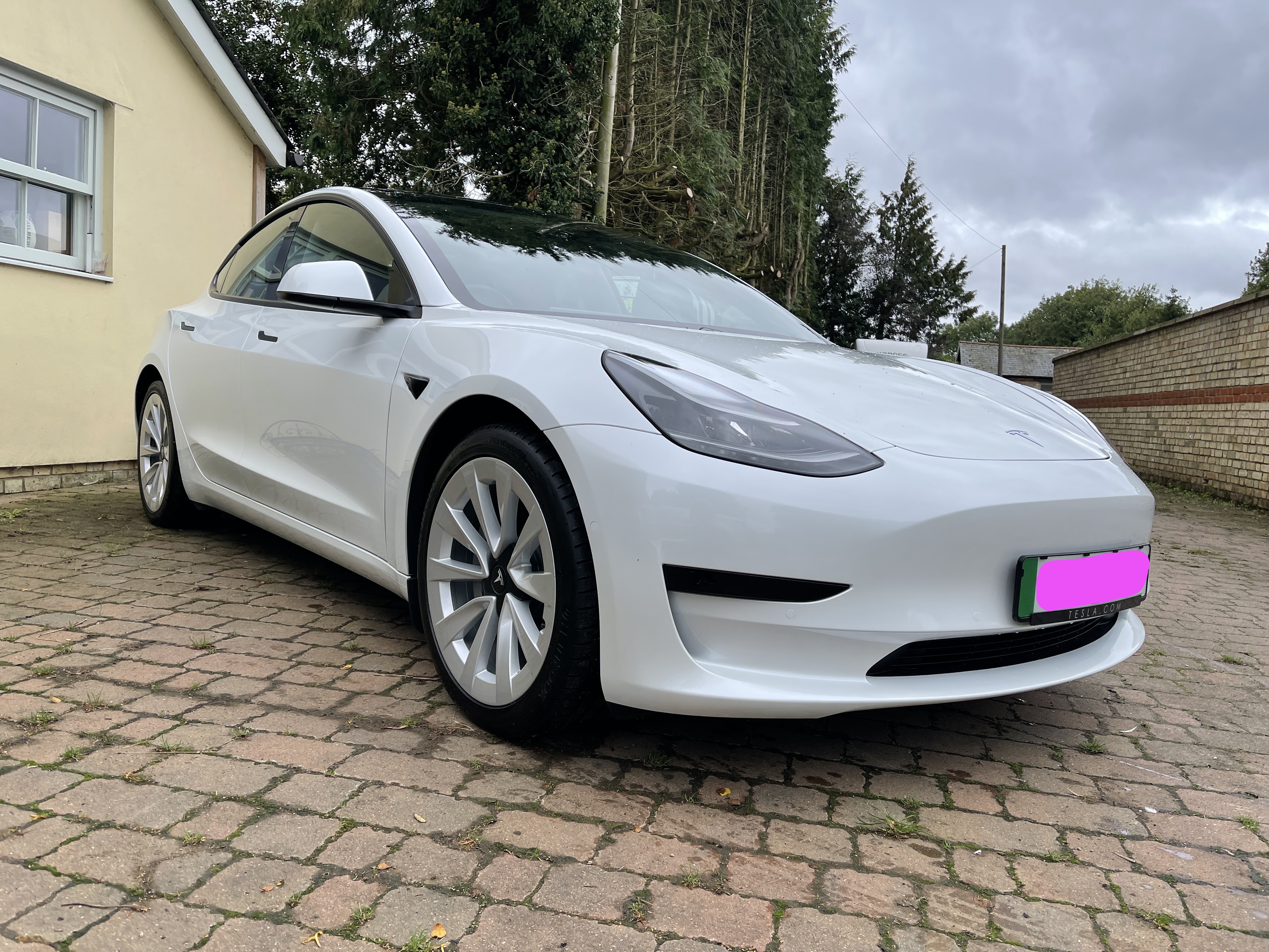A photo of my new Tesla Model 3 in white with sports wheels A photo of my new Tesla Model 3 in white with sports wheels